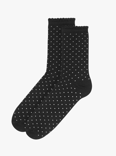 Schwarze Socken mit beigen Tupfen und Rüschenbesatz