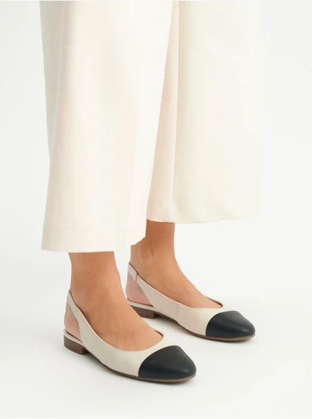 Cremefarbene und schwarze Slingback-Ballerinas
