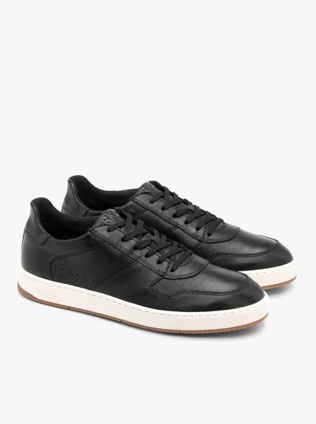 Schwarze halbe Sportschuhe mit weißem und beigem Untergrund